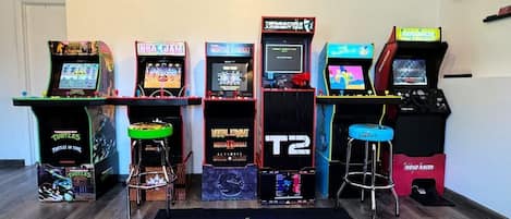 The game room with machines, a dart board, and board games will be everyone's favorite place to play!