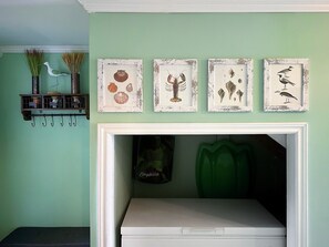 Captain's suite entry hallway with coat rack, bench, and marine-themed decor