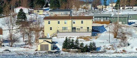 The rear of the house and its backyard on a cold, sunny day in winter