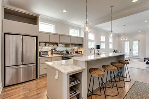 Create savory dishes or enjoy heartfelt chats over morning coffee in this inviting kitchen.