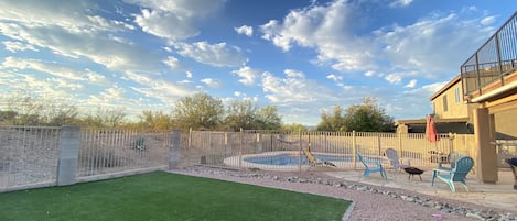 Turf area, fire pit, pool and covered patio