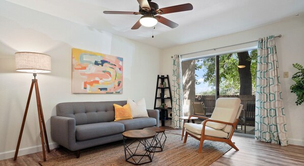 Living room with smart tv, comfortable seating and patio