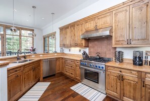 Fully stocked Spacious Kitchen with modern stainless steel appliances and gas burning stove.