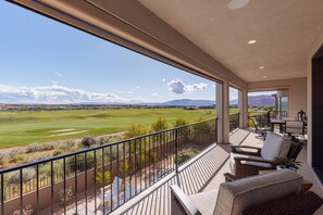 Balcony Patio Seating and View - Motorized shades can be lowered or raised for added shade or protection from bugs.