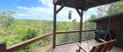 Back porch with swing, chimes, and a weber grill. Great spot to watch sunset!