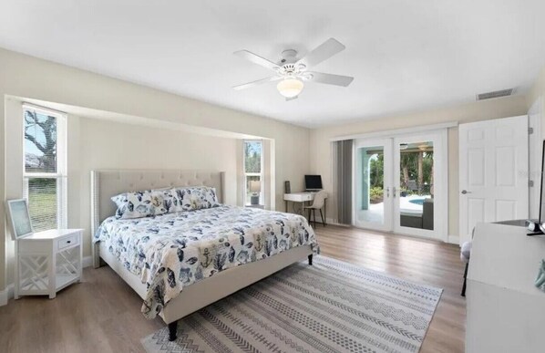 Master Bedroom with desk and chair with french doors to the lanai