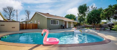 Spacious and well maintained backyard with salt water pool, bbq grill, outdoor games, large green space, and outdoor seating. Enter into your own private oasis.