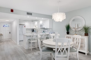 Dining table for four and breakfast bar in kitchen with seating for three