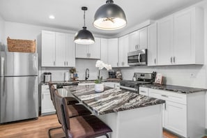 Sleek updated kitchen stacked with all of the necessities, modern appliances + ice machine