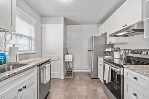 Sleek updated kitchen stacked with all of the necessities, modern appliances