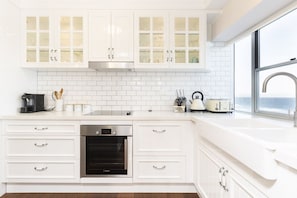 The kitchen is a equipped with top-of-the-line European appliances and an array of cooking equipment
