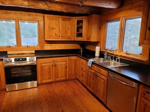 Large kitchen, with gleaming new appliances provides space for multiple cooks.