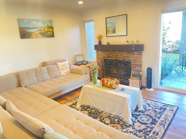 Living room and gas fireplace with sliding glass doors to dedicated backyard.