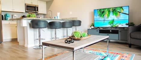 Breakfast bar and living room area with smart TV and cable