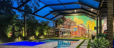 A stunning custom mural adorns the back wall of the courtyard
