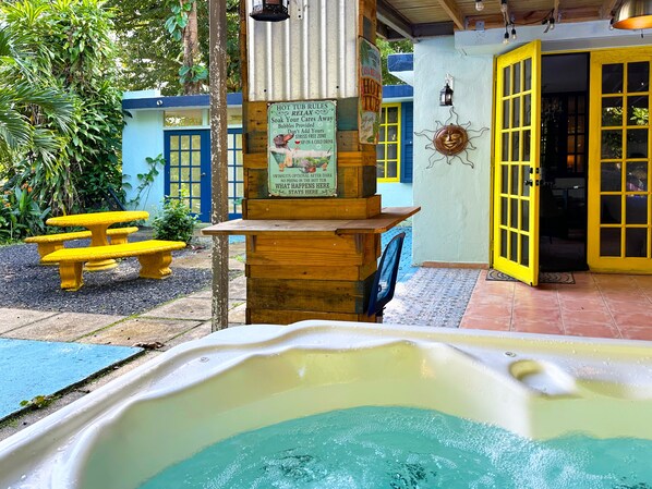 Enjoy the 5 person spa in the tropical backyard