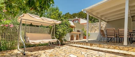 A shaded swing near the orange tree for your relaxation.