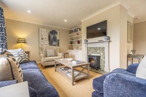 Ground floor: Sitting room with ample seating and a Smart television