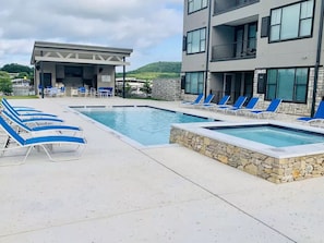 Community Pool and Spa with outdoor grill and dining area.