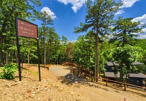 A welcoming sign marks the entrance to your woodland escape, where adventure and tranquility meet.
