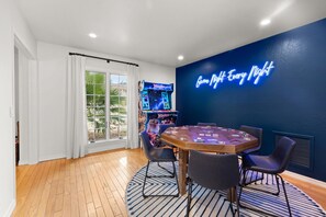 Standing arcade game and poker table complete the game room!