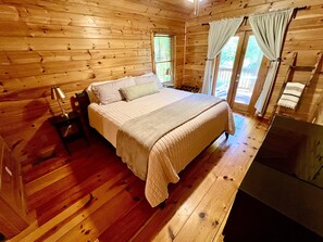 Main bedroom upstairs with king bed, private bathroom, and private balcony
