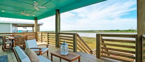 Covered deck with abundant seating and a scenic view of Paradise Pointe.