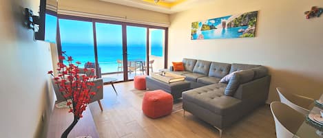 Enjoy the breathtaking ocean view from this comfortable living room with plenty of seating.