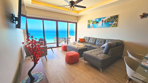 Enjoy the breathtaking ocean view from this comfortable living room with plenty of seating.