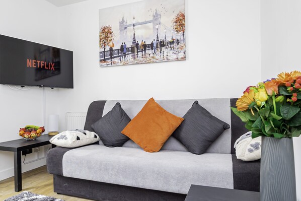 Relax in our inviting living room, featuring a comfortable sofa perfect for unwinding after a day of exploring.