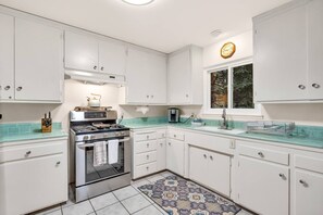 The bright and open kitchen provides plenty of counter space for cooking or baking.