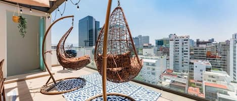 Rooftop area with great city views, BBQ, outdoor dining table & hanging chairs