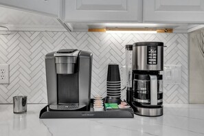Coffee area equipped with Keurig, 14 cup coffee pot, K-cups, sweeteners, and creamers