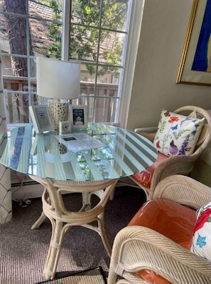 Dining table with two comfortable chairs overlooking the forest.
