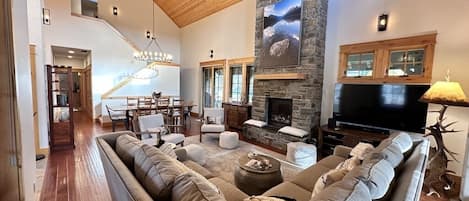 Large living space with fireplace, TV and formal dining