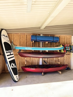 2 kayaks, 2 standup paddle boards, splash pad, and life vests provided