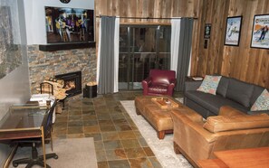 The spacious living room has radiant heated floors and a wood-burning fireplace