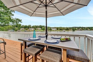 Enjoy serene lake vistas from your cozy outdoor lounge.