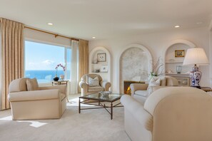 Secondary sitting area with a fireplace and large windows.