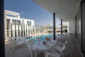 garden with barbecue, seating area, sunloungers, outside shower and private pool