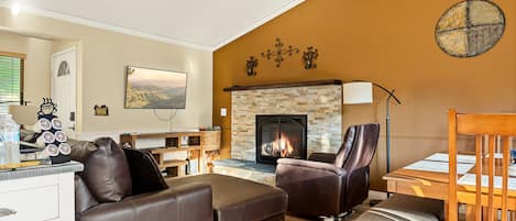 Curl up in the inviting living room to enjoy a movie by the fireplace