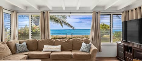 Receive a warm Aloha in the cozy family den, where ocean views and gentle breezes enhance your homey experience.