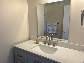 New bathroom vanity with large counter and storage space