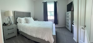 Front bedroom with closet, dressers and queen bed