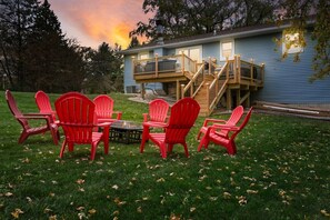 Deck, hot tub, furniture, charcoal grill, fire pit, and games highlight our large back yard.