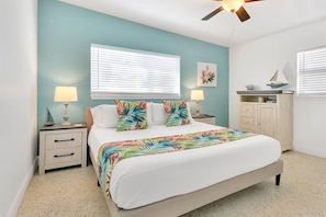 Large primary room with king bed, Roku TV, and tropical vibe. Includes a pack and play portable crib