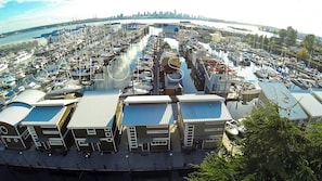 Drone shot of the Mosquito Creek Marina, the same perspective as our patio, facing out towards downtown Vancouver.