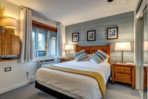 The primary bedroom with blue shiplap and beautiful ski photos framing the bed. We now have a California king bed (see later photo).