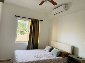 Bedroom 1, complete with full bed + AC + small closet