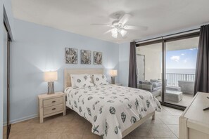 Main bedroom with queen-size bed and access to balcony.